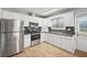 Modern kitchen, featuring stainless steel appliances and white cabinets at 8109 San Jacinto Ave, North Port, FL 34287