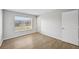 Well-lit bedroom featuring wood-look floors and a window at 8109 San Jacinto Ave, North Port, FL 34287