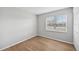 Bright bedroom featuring wood-look flooring and a large window at 8109 San Jacinto Ave, North Port, FL 34287
