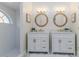 Bright bathroom featuring shiplap walls, dual sinks, and a modern tiled shower with a window at 956 Harbor Town Dr, Venice, FL 34292