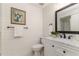 Charming bathroom with shiplap walls, marble countertop, and a decorative mirror creating a relaxing space at 956 Harbor Town Dr, Venice, FL 34292