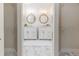 Elegant bathroom featuring dual sinks, stylish wood framed mirrors, and marble flooring at 956 Harbor Town Dr, Venice, FL 34292