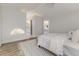 Sunlit bedroom provides a view of an ensuite bathroom and a calming color palette at 956 Harbor Town Dr, Venice, FL 34292