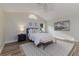 Bright bedroom featuring vaulted ceiling, accent wall, bench and stylish patterned rug at 956 Harbor Town Dr, Venice, FL 34292