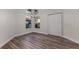 Bright bedroom featuring new flooring, large windows, and a spacious closet perfect for comfort and organization at 956 Harbor Town Dr, Venice, FL 34292