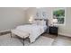 Comfortable bedroom showcasing a serene window view and a cozy white comforter on the bed at 956 Harbor Town Dr, Venice, FL 34292