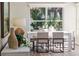 Bright dining area featuring a contemporary table set by a window with tropical outdoor views at 956 Harbor Town Dr, Venice, FL 34292