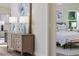Inviting entryway features a console table with lamps and artwork, leading into a serene bedroom space at 956 Harbor Town Dr, Venice, FL 34292