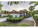 Beautiful home with a tile roof, two-car garage, and tropical landscaping at 956 Harbor Town Dr, Venice, FL 34292