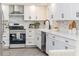 Modern kitchen featuring white cabinets, stainless steel appliances, and a farmhouse sink at 956 Harbor Town Dr, Venice, FL 34292