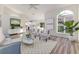 Bright living room with vaulted ceiling, wood floors, modern decor and large window at 956 Harbor Town Dr, Venice, FL 34292
