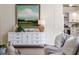 Open-concept space with white credenza leading into a bright kitchen with modern appliances at 956 Harbor Town Dr, Venice, FL 34292