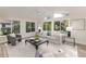 Bright sunroom with vaulted ceiling, wood floors, tasteful decor and large windows at 956 Harbor Town Dr, Venice, FL 34292