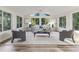 Bright sunroom featuring many windows, vaulted ceiling, wood floors and tasteful decor at 956 Harbor Town Dr, Venice, FL 34292