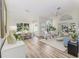 Bright living room with wood floors, vaulted ceilings, and modern decor at 956 Harbor Town Dr, Venice, FL 34292