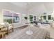 Inviting living room with white walls, wood floors, vaulted ceiling, and many windows at 956 Harbor Town Dr, Venice, FL 34292