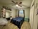 Cozy bedroom with a full-size bed, ample closet space, and a ceiling fan at 20246 Hamilton Ave, Port Charlotte, FL 33952