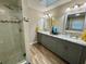 Double vanity bathroom with granite countertops and a large walk-in shower at 20246 Hamilton Ave, Port Charlotte, FL 33952