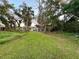 Overgrown lot with mature trees and tall grass at 20246 Hamilton Ave, Port Charlotte, FL 33952