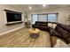 Spacious living room featuring a large sectional sofa and wood-look tile floors at 20246 Hamilton Ave, Port Charlotte, FL 33952