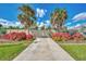 Attractive driveway entrance with lush landscaping and gated access at 2291 Meetze St, Port Charlotte, FL 33953