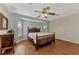 Bedroom with ceiling fan, wicker bed frame, and wood floors at 2291 Meetze St, Port Charlotte, FL 33953