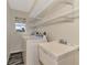 Laundry room with washer, dryer, utility sink, and ample shelving at 2291 Meetze St, Port Charlotte, FL 33953