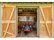 Outdoor storage shed with lawnmower and tools at 543 Lincoln Nw Ave, Port Charlotte, FL 33952