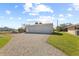 Detached three-car garage with gravel driveway at 543 Lincoln Nw Ave, Port Charlotte, FL 33952