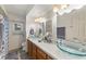 Bathroom with double vanity, glass sinks, and large mirror at 543 Lincoln Nw Ave, Port Charlotte, FL 33952