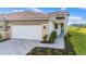 Modern home exterior with two-car garage and landscaped walkway at 11247 Boundless Ter, Venice, FL 34293