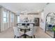 Bright dining area with glass table and four light-grey chairs at 11247 Boundless Ter, Venice, FL 34293