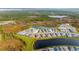 Aerial view of houses around a lake in Brightmore community at 11247 Boundless Ter, Venice, FL 34293