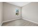 Bedroom with wood-look floors and window at 2404 Hanford Ln, North Port, FL 34288