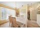 Bright dining room with a table set for a meal and access to laundry at 18404 Lake Worth Blvd, Port Charlotte, FL 33948