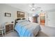 Main bedroom with a queen-size bed, dresser, and access to the bathroom at 18404 Lake Worth Blvd, Port Charlotte, FL 33948