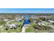 Bird's eye view of a waterfront property with a house and surrounding neighborhood at 18404 Lake Worth Blvd, Port Charlotte, FL 33948