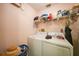 Laundry room with washer, dryer, and shelving for storage at 18404 Lake Worth Blvd, Port Charlotte, FL 33948