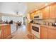 View of kitchen with wood cabinets, appliances, and a breakfast bar at 18404 Lake Worth Blvd, Port Charlotte, FL 33948