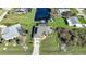 Aerial view showcasing a single-story home with a private pool and canal access at 18404 Lake Worth Blvd, Port Charlotte, FL 33948