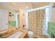 Clean bathroom with single sink, shower/tub combo, and patterned shower curtain at 18404 Lake Worth Blvd, Port Charlotte, FL 33948