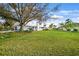 Spacious backyard with large tree and grassy lawn at 1124 Cheshire St, Port Charlotte, FL 33953