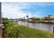 A spacious backyard with boat dock, seawall and lush landscaping, perfect for waterfront living at 1215 Via Tripoli, Punta Gorda, FL 33950