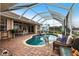 Stunning kidney-shaped pool with screened enclosure and comfortable seating at 1215 Via Tripoli, Punta Gorda, FL 33950