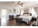 The main bedroom has neutral tones, ceiling fan, hard wood floors, and decor at 1215 Via Tripoli, Punta Gorda, FL 33950