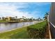 Tranquil waterfront views with manicured lawn and mature landscaping at 1215 Via Tripoli, Punta Gorda, FL 33950