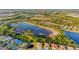 Aerial view showcasing a community with a large lake and natural surroundings at 2765 Arugula Dr, North Port, FL 34289