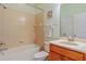 Bathroom with tile floors, a single sink, tile shower and tub, and soft green paint at 2765 Arugula Dr, North Port, FL 34289