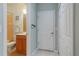 Bathroom with tile floors, a single sink, tile shower and tub, and white door at 2765 Arugula Dr, North Port, FL 34289