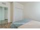 Bedroom with light-colored walls, wood floors, closet, and neutral-colored bedding at 2765 Arugula Dr, North Port, FL 34289